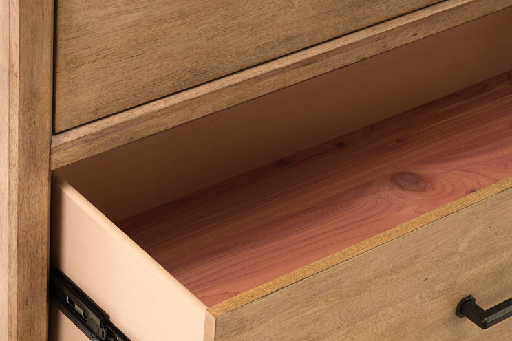 Wooden drawer with a metal handle on a wooden cabinet.
